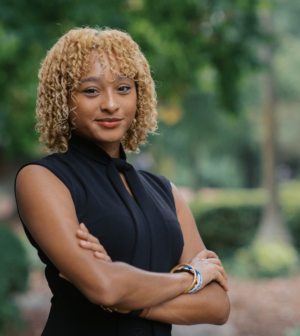 Teresita Cabral standing in front of the Administration Building