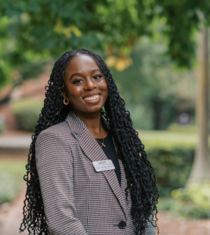 Tedra Ibegbulam standing in front of the Administration Building