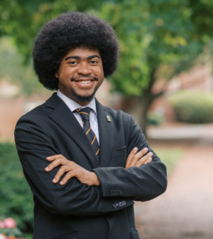 Micah Scott standing in front of the Administration Building