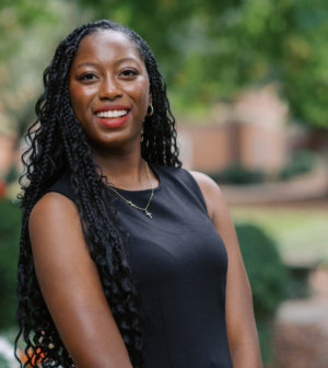 Zoë Allen standing in front of the Administration Building